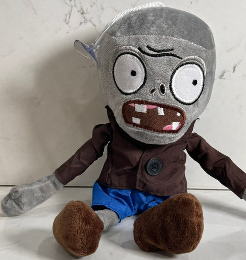 Plush toy with a gray head, brown jacket, and blue pants on a light background